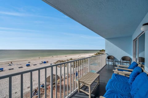 Covered balcony w/ seating and wide views of sandy dunes and blue skies.