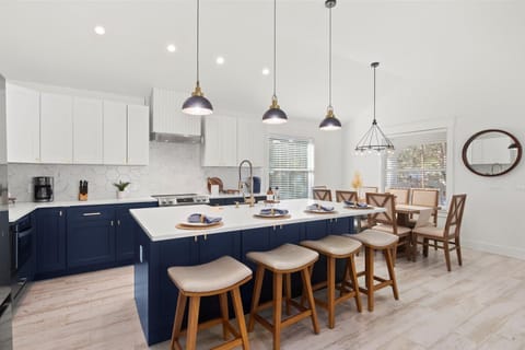 Create Meals and Memories: Gather around the sleek kitchen island, offering seating for 4 under warm pendant lighting—a perfect spot for casual meals and lively conversations.