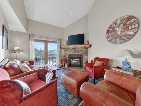 Sink into luxurious leather seating by your crackling fireplace, where mountain views and rustic charm create the perfect retreat.
