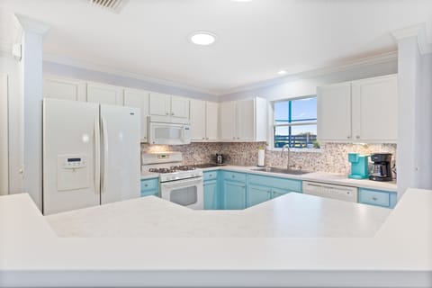 Large kitchen with French door refrigerator and gas cooking