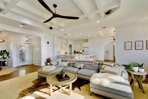 the main living room (there are two living rooms) has a plush U-shaped leather sofa and a swing chair