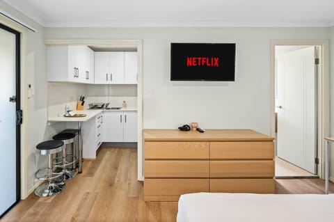 Studio: Compact studio featuring bed, kitchenette, and wall TV 
