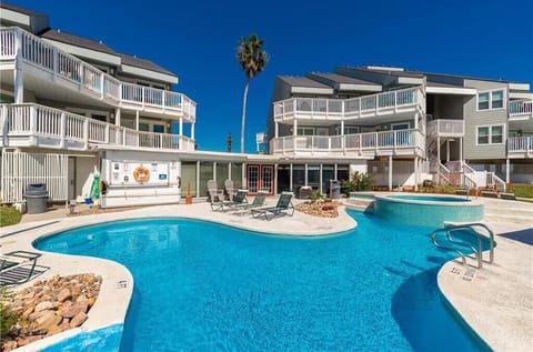 Crystal clear waters await in this inviting pool complex, perfect for soaking up the sun on your beach vacation.