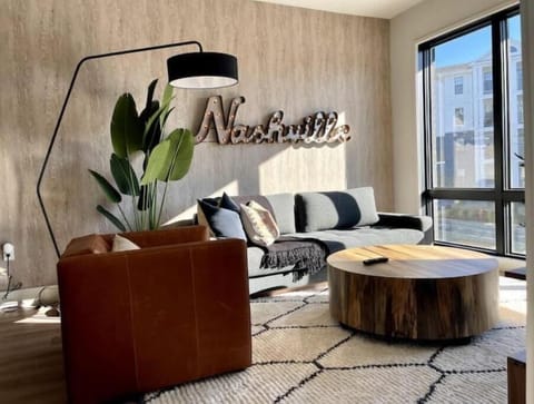 Bright living room-comfortable seating, smart TV, designer decor, queen sleeper