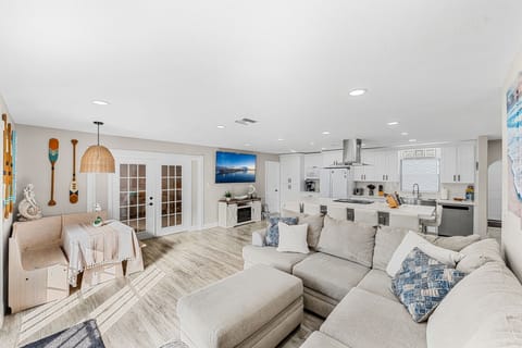 Open layout combining the dining, living, and kitchen areas, creating a spacious and seamless flow for easy living and entertaining.