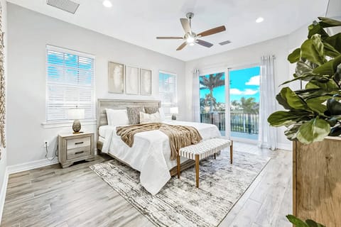 Master bedroom with a plush bed, warm tones, and private balcony access.
