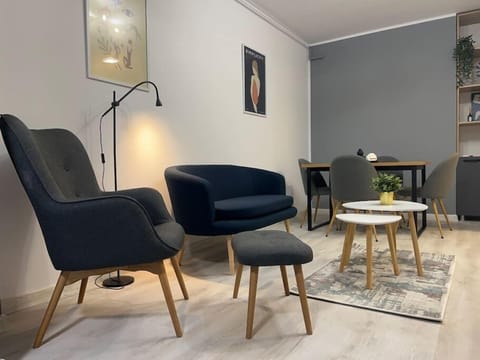 Living room with sofa, Smart TV and dining table for 4