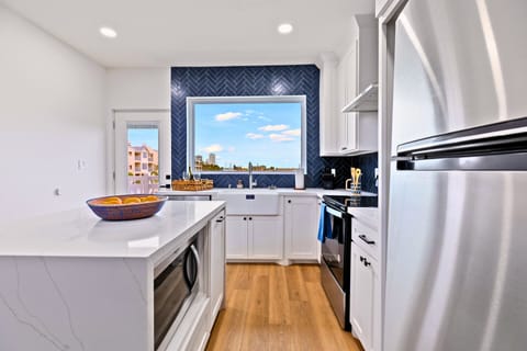 Enjoy cooking in a beautifully designed kitchen with a spacious island, modern finishes, and all the cookware and essentials to make you feel right at home.