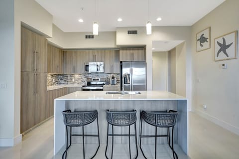 The waterfall edge kitchen island has additional seating for 3