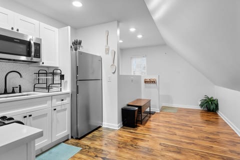 Your bright, fully-equipped kitchen features modern appliances and warm hardwood floors, perfect for preparing home-cooked meals during your stay.