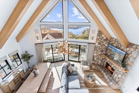 A bright open concept living space with fireplace, smart TV and views.