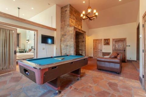 Step into this charming game room where you'll love challenging friends to a game of pool. With its cozy seating, flat-screen TV, and warm ambiance, this space is perfect for relaxation and entertainment after a day of adventure.