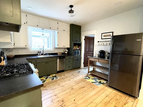 Kitchen with gas range, dishwasher, garbage disposal, and microwave