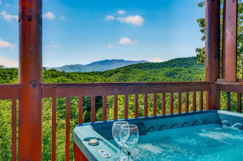 Soak in the hot tub while drinking in sweeping views of lush forests and mountain peaks—a peaceful retreat where relaxation meets stunning natural beauty.