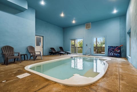 Soak away your cares in your private indoor pool, complete with lounge chairs and serene natural light streaming through large windows—perfect for relaxing any time of year.