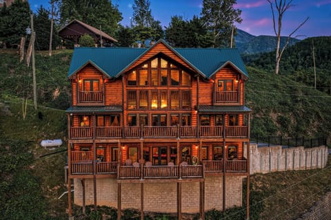 This stunning log cabin sits nestled against forested mountains, offering a serene mountain retreat. Multiple balconies and expansive windows invite natural light and breathtaking views throughout your stay.