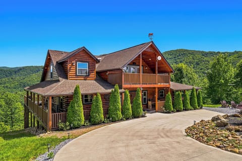 A spacious log cabin nestled in lush mountains with private parking and landscaped grounds, offering a perfect mountain retreat surrounded by nature.