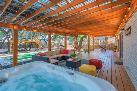 enormous patio with hot tub and a view