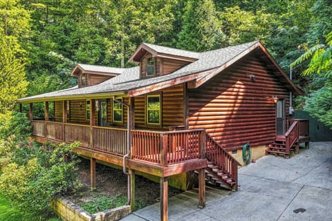 This rustic log cabin is surrounded by lush forest and features a spacious wraparound deck perfect for outdoor relaxation. The natural wood design and peaceful wooded setting create a private mountain retreat.