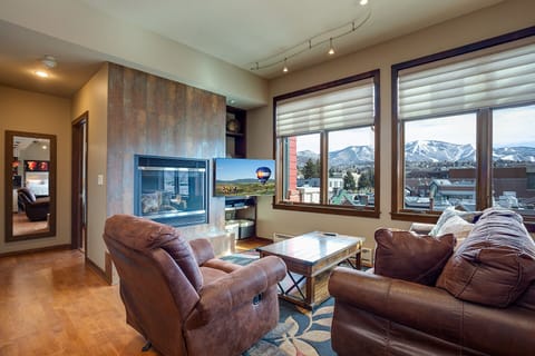 Sink into plush leather seating while mountain vistas frame your cozy evenings by the modern fireplace.