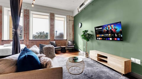 Living Room: Stylish retreat with vibrant decor, large windows, and a perfect spot for movie nights!