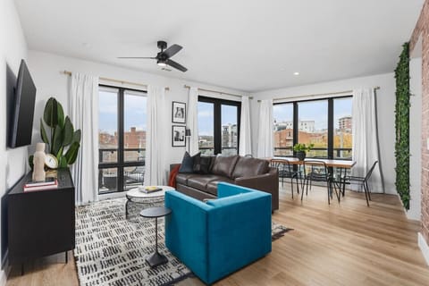 Spacious living room with a Smart TV, comfortable seating and lots of natural light. The dining table has seating for six.