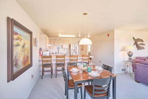 Dining area seats four at the table and four at the bar.