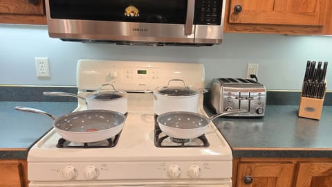 Gas Stove with Pans, Toaster, and Knives