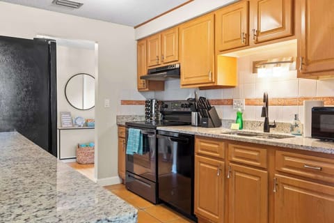 {KITCHEN} The spacious granite counter tops provide ample space for meal preparation, while the modern amenities ensure that cooking is a breeze. We've provided all the necessary kitchen amenities, so you can prepare and enjoy delicious meals.