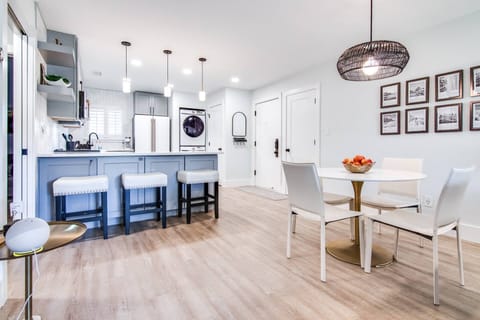 Dining area with seating for four along with seating area at the bar for three!