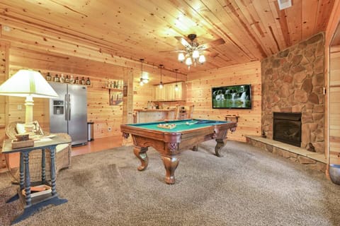 Basement hangout area - features pool table, fireplace, bar area and TV.
