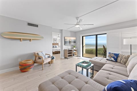 Coastal living room with a stylish sectional sofa and private ocean front balcony