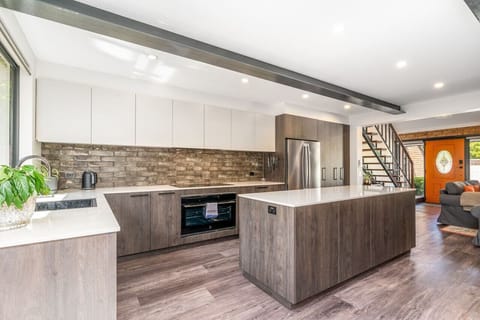 An airy open-plan layout combining kitchen, dining, and lounge in one inviting space.