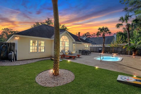Fun backyard with a fire pit, grill, loungers, and a plunge pool.