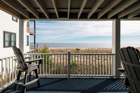 Savor morning coffee on your private balcony as ocean waves and endless horizons create the perfect coastal escape.
