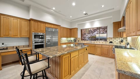 Bright kitchen with modern appliances, granite countertops, and views.