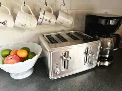 Stocked kitchen includes toaster and coffee pot.