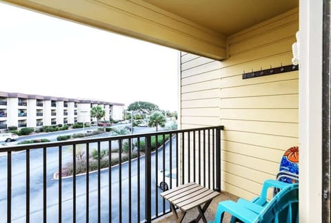 One balcony features a classic black-and-white striped awning.