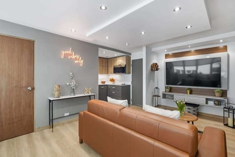 The living room features a flat screen TV, comfortable sofa and high speed wifi.