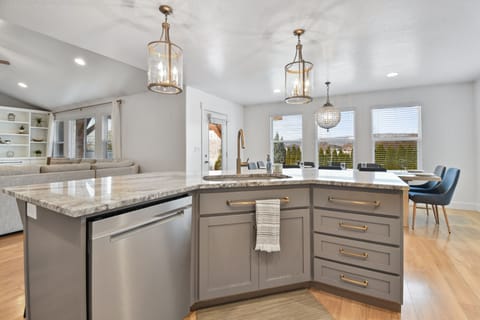 A fully equipped chefs kitchen with massive island that seats 6, plus a dining table that seats 12 for a total of 18 in the kitchen dining area.
