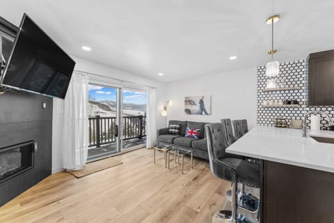 Your stylish mountain retreat features modern furnishings, a cozy fireplace, and stunning ski slope views from your private balcony.