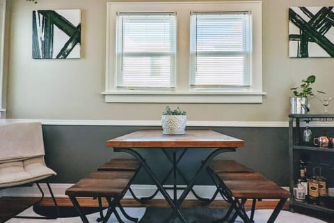 Straight on view of dining room table and bar cart