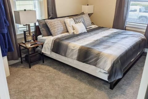 Bedroom 1- King Helix Midnight Memory Foam mattress with balckout curtains, Smart TV, and walk-in closet with hanging space and shelves
