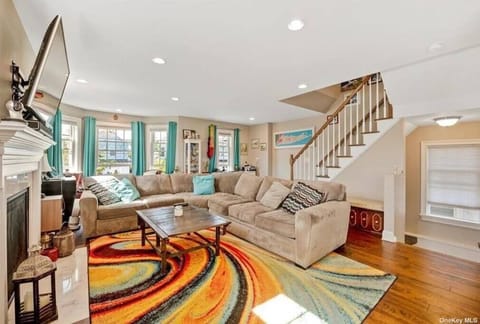Open Concept living room with fireplace and TV 