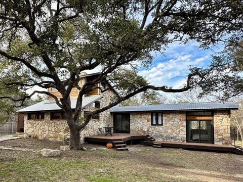 Home sits in the middle of 2-acres of land and shaded by oak trees