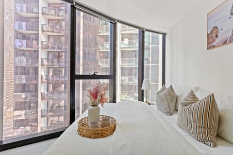 The master bedroom with a queen sized bed & plush pillows.