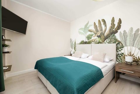 The living area features a flat-screen television.
