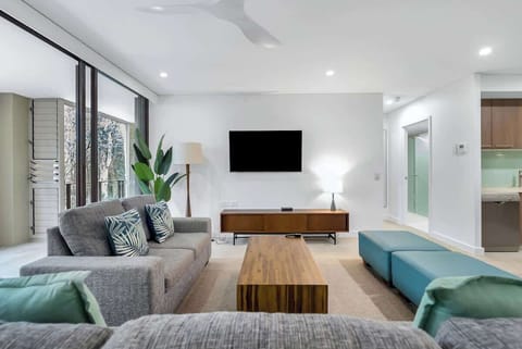 The breezy living area is set with two comfortable lounges fronting a smart TV.  