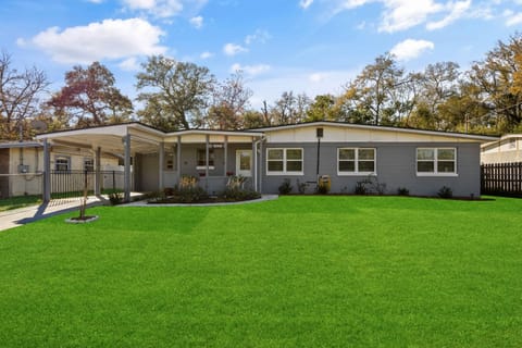 Exterior property with fenced yard and parking space.