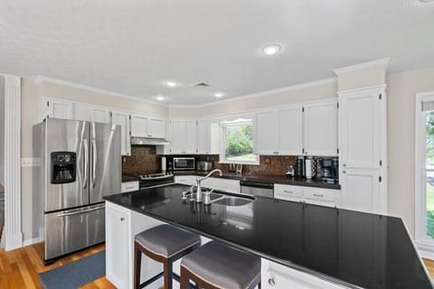 Beyond the kitchen food prep Island, a full range of appliances host the kitchen. Filtered water and ice is offered at the full sized refrigerator… a dishwasher is also provided. 